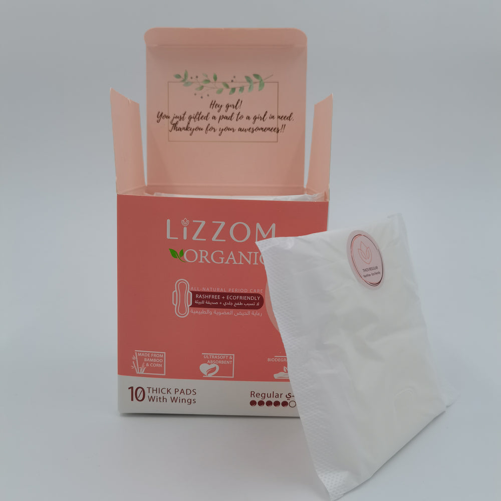 LiZZOM Organic THICK Night Pads, Regular, coral box opened with a wrapped pad