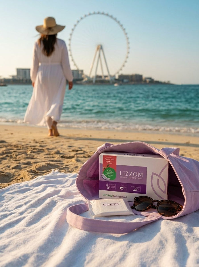 Woman walking toward the sea at JBR with a LiZZOM box in her beach bag