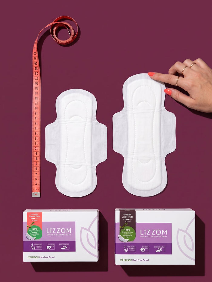 Regular 245 mm and Large 285 mm ultrathin pads beside a tape measure
