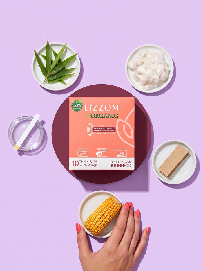 LiZZOM thick pad box surrounded by bamboo, corn, plant fibre and a pH strip